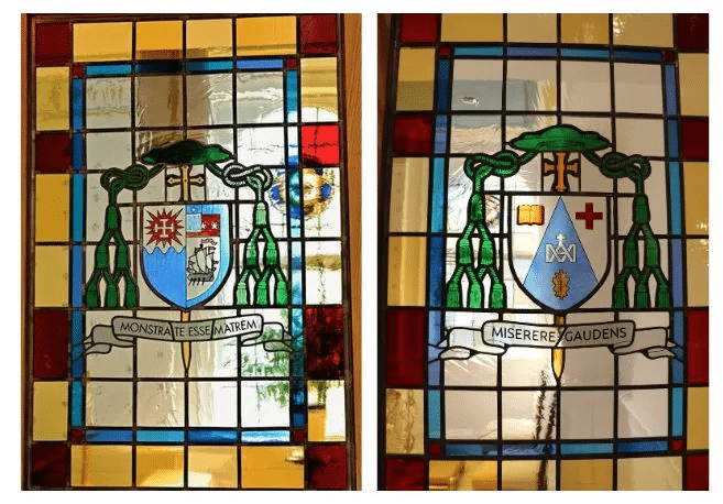 Glass windows with crests and inscriptions